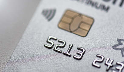 Detail of a silver Credit card with a chip, close-up background