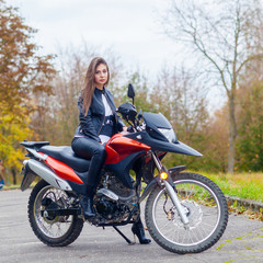 Fototapeta na wymiar Portrait of a beautiful hipster girl on a sports motorcycle