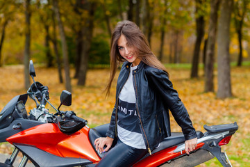 Obraz na płótnie Canvas Portrait of a beautiful hipster girl on a sports motorcycle