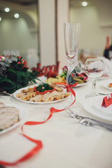 Elegant champagne flute with red ribbon around it