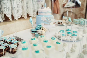 Sweets covered with white and blue glaze stand served on dinner