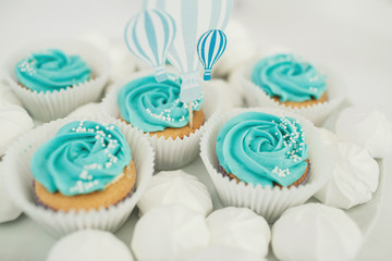 Pretty cupcakes with blue glaze and little white pearls