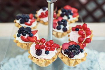 Baked basckets with cream and berries