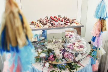 Glass table with hydrangeas and sweets
