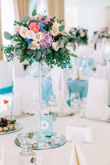 Bouquet of beige roses and pink hydrangeas stands in the centre