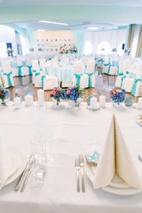 Beige serviette stands in the form of triangle on white dinner p