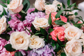 Close-up of white and pink roses put in a bouquet of violet hydr