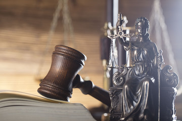 Law and justice concept. Scales of justice, gavel, paragraphs, brown wooden background, place for...
