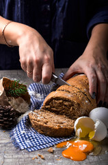 Female hands slicing homemade bread