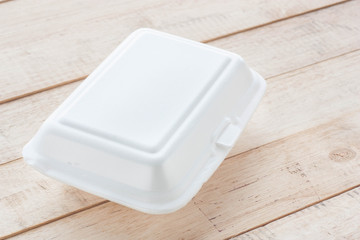 Foam box on wood background.