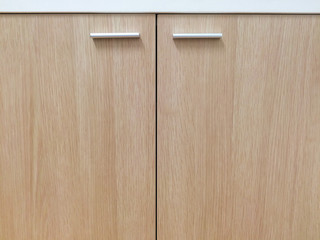 Closeup wooden cabinet / cupboard doors with handles for background