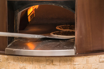 A pizza in a oven burning
