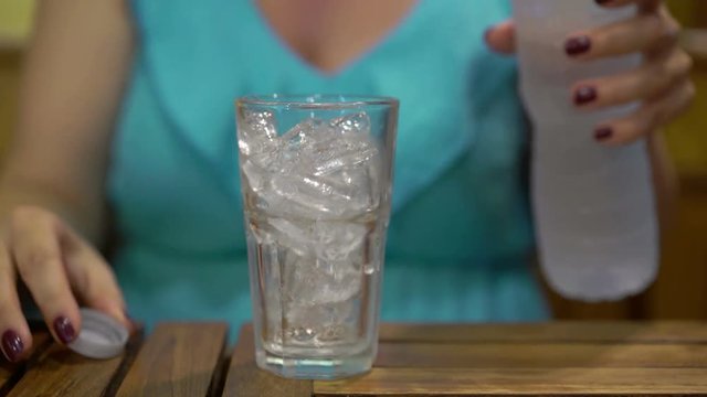 Young woman drinking water in restaurant