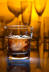 whiskey with natural ice on a glass table in bar