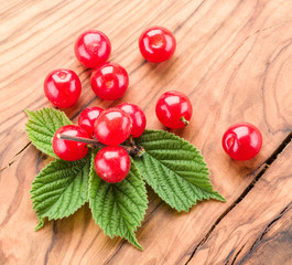Nanking or felted cherry ftuits with leaves on the wooden table.