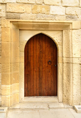 Traditional wooden door with arch in Old city, Icheri Sheher. Baku