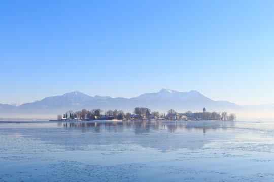 Island Fraueninsel on partly frozen Lake Chiemsee in Bavaria, Germany, on a cold winter day