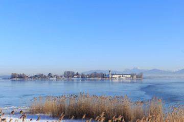 Island Fraueninsel on partly frozen Lake Chiemsee in Bavaria, Germany, on a cold winter day