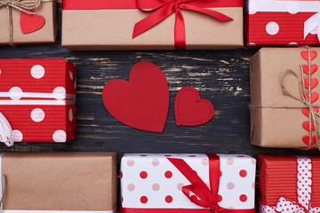Two greeting card heart shaped surrounded by gift boxes