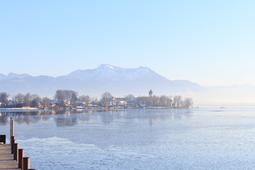 Fototapeta na wymiar Island Fraueninsel on partly frozen Lake Chiemsee in Bavaria, Germany, on a cold winter day