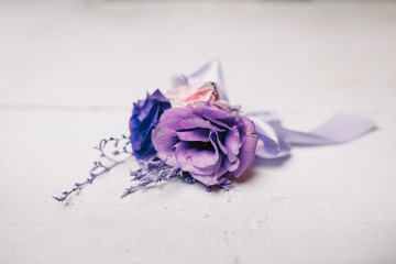 Tender violet and blue flowers put in a boutonniere