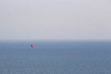 minimalism human scale of lonely kite surfing at sea