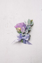 Beautiful boutonniere made of violet flowers and twined with vio