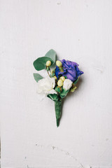 Boutonniere made of blue rose and white pink