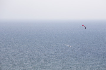 minimalism human scale of lonely kite surfing at sea