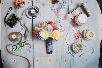 Little wedding bouquet with dark blue riibon lies on florist's w
