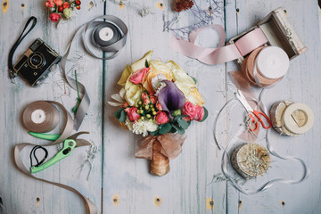 Fototapeta na wymiar Bouquet of flowers and berries lies on florist's working table