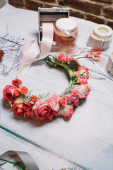 Bouquet of tender pink and red roses lies on florist's wooden ta