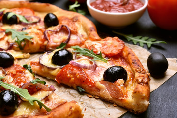 Pizza with tomato, salami and olives