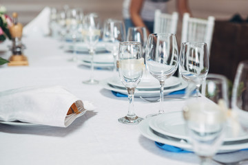 Champagne flutes decorated with silk ribbons and brooches stand