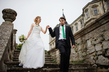 Loving wedding couple at their happy wedding day background old