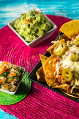Tasty nachos with cheese and salsa