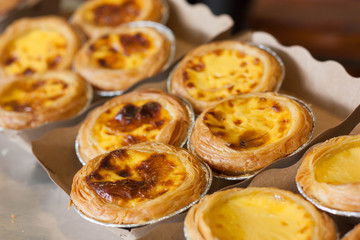 Egg tart or portuguese egg tart on recycled paper.
