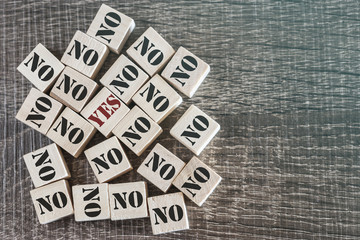 Positivity and decision making concept with Yes and No words on wooden blocks