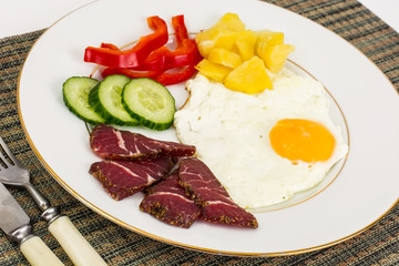 Fried egg with vegetables and a side dish of potatoes with mushr