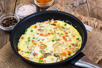 Omelet with vegetables in a pan