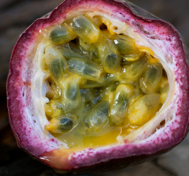 Macro shot of the cutted fresh passion fruit on rustic vintage w