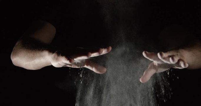SLOW MOTION closeup of an athlete hands clapping with white chalk powder, take 2