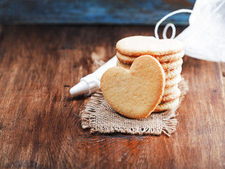 Valentine cookies with heart shape on wooden background with free text space. Selective focus.