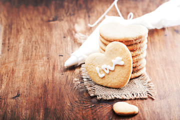 Valentine cookies with heart shape on wooden background with free text space. Selective focus.