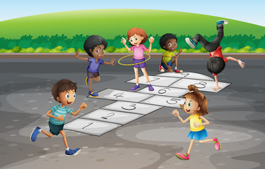 Many children playing hopscotch in the park