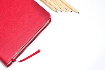 Fototapeta premium Dairy, notebook and pencils on white office background.