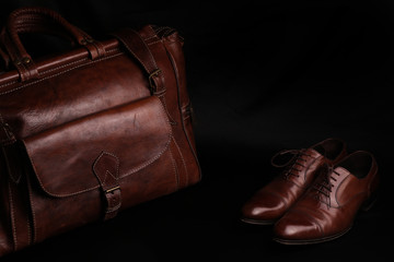 Luxury leather brown men's accessories, travel bag, shoes. isolated on black background