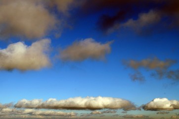 Blue sky with white fluffy clouds on a clear day