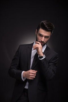 young man elegant suit jacket posing hands black