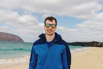 handsome man in glasses on the beach